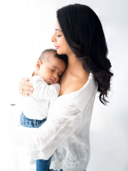 A peaceful moment of a mother holding her sleeping baby close.