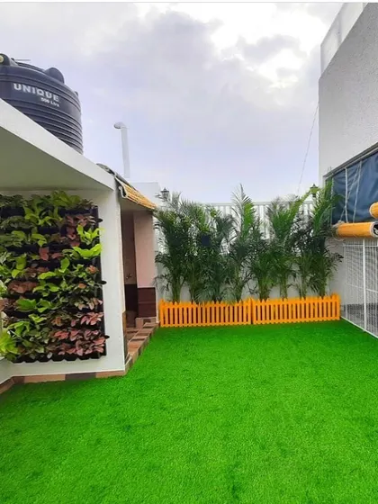 This terrace project showcases a combination of our services. We installed a full artificial lawn, a vertical garden for a splash of wall color, and a row of areca palms for a tropical feel.