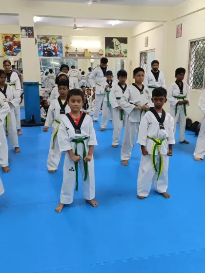 Students in a ready stance (Jumbi Seogi), showing focus and discipline as they prepare to practice their forms.