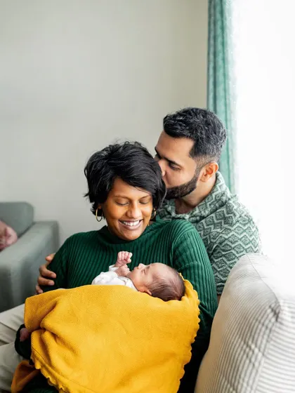 There's so much love in this cozy family portrait on the couch. At-home lifestyle sessions are all about capturing your family's authentic connections in your own comfortable space.