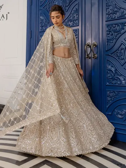 This radiant golden lehenga with its intricate geometric embroidery and fine beadwork is ideal for the bride who commands attention with every step.