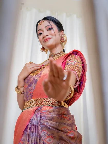 A playful and confident pose from a happy bride. Her makeup is fresh and radiant, designed to last all day and look perfect in every photograph.