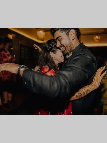 A warm, happy hug on the dance floor during the Sangeet.
