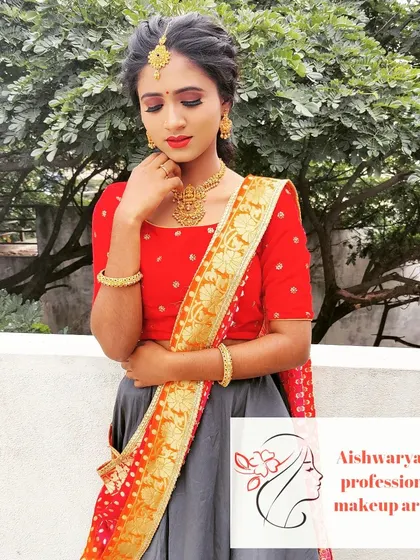 A vibrant and fresh look for a sangeet night. The makeup features defined eyes and a bold lip that complements her colorful half-saree, perfect for a night of celebration.
