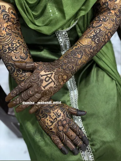 A beautiful close-up of the personalized palms, with the initials 'A' and 'T' and the name 'Atif' in Arabic.