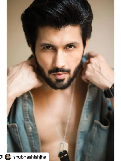 A striking portrait of actor Shubhashish Jha. His hair is styled to be sharp and defined, complementing his strong features.