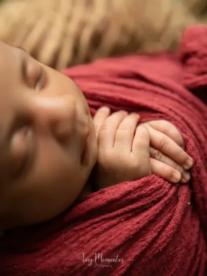 A detail shot of the baby's tiny hands clasped together while she sleeps. These are the "tiny moments" that pass by so quickly and are so important to preserve.