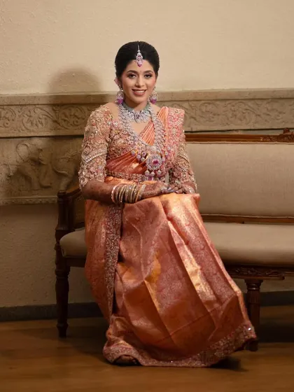 A full view of this regal bride. The heavily embroidered blouse with 3D floral details is a true statement piece, perfect for a grand celebration.
