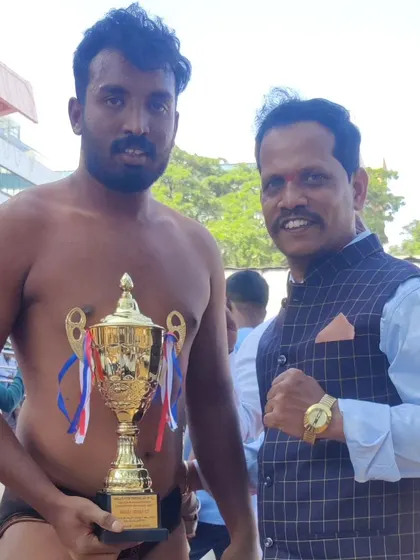 Congratulating my student Prem on his victory. He holds the trophy he earned through sheer grit and hard work in the Dangal.