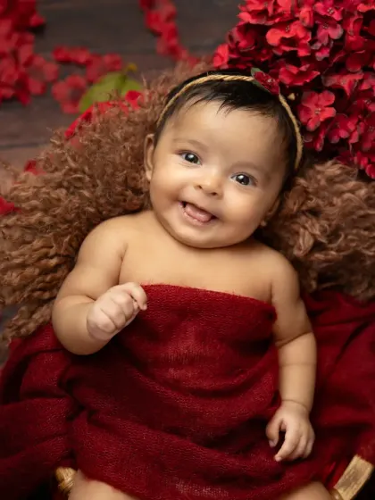 Those first few weeks are so precious. As a certified newborn photographer, I ensure your baby is safe and comfortable, allowing us to capture sweet, sleepy smiles and tiny details like this in a warm, simple setup.