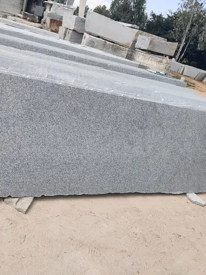 A solid grey granite slab, 20mm thick. This is a versatile stone suitable for many applications, from kitchen counters to outdoor paving.