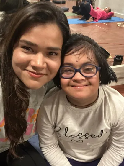 This is me with Chinmayee, a student who has become one of my greatest teachers. Her joy and patience remind me daily of the true purpose of my work.