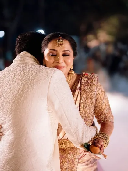 A touching hug between the bride and groom after their wedding ceremony.