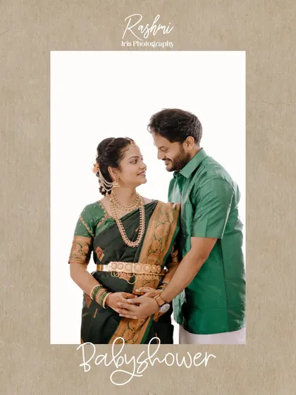 A classic portrait of a couple at their baby shower. Dressed in traditional green outfits, they stand together, with the husband's hands gently placed on his wife's baby bump.