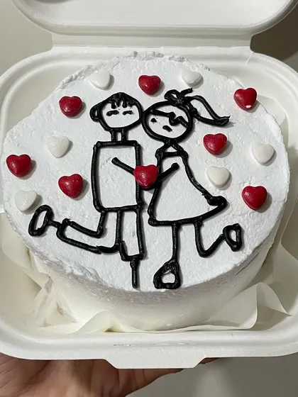 A romantic bento cake with a cute couple drawing, perfect for Valentine's Day or an anniversary.