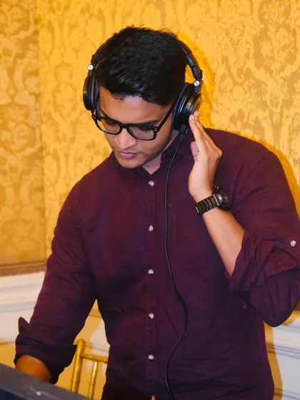 In the zone at a wedding event. My headphones are essential for cueing up the next track perfectly, ensuring there are no awkward silences.