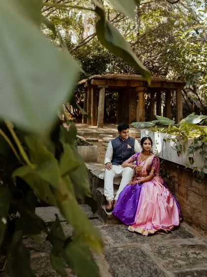 Framed by the rustic charm of The Tamarind Tree, this couple shares a look of love. We specialize in using unique angles and architectural elements to create memorable wedding portraits.