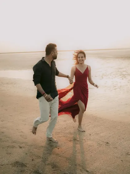 A playful, running shot on the beach, full of energy and happiness. This captures the fun side of a couple's relationship.