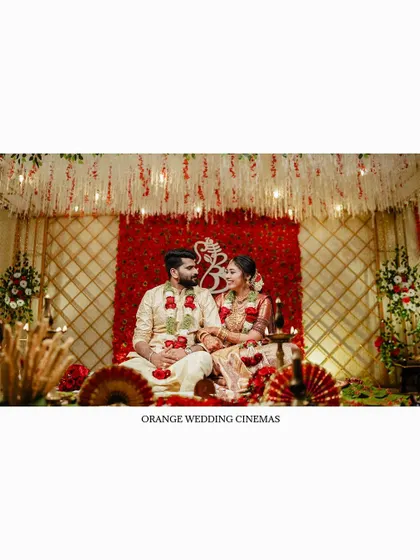 A wide shot of the couple on their beautifully decorated wedding mandap.