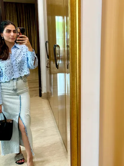 A mirror selfie from my "selfie week," wearing a blue eyelet shirt and a denim skirt.