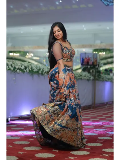 A fun, twirling shot in the floral print lehenga. The lightweight georgette fabric gives it beautiful movement, perfect for a lively celebration.