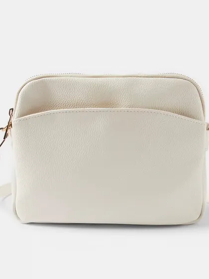 A front view of the off-white Australia Crossbody bag. The gold hardware gives it a classic and polished finish.