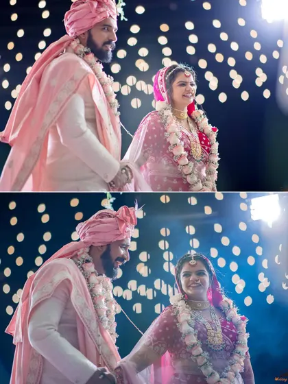 The couple taking their seven steps together during the pheras, beautifully lit against a backdrop of bokeh lights.