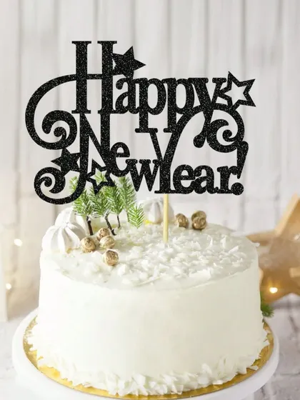 A "Happy New Year" topper in black glitter with star and swirl details, adding a festive touch to your party.