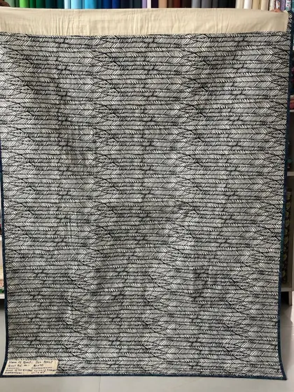 The back of the award-winning sea quilt, featuring a subtle wave-like fabric.