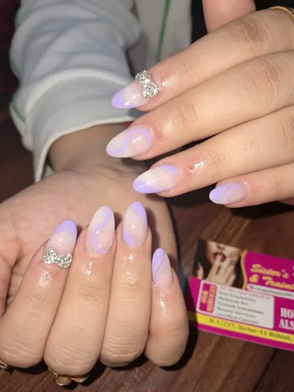 A pretty pastel purple design with abstract swirls and 3D stone bows for a cute and glamorous finish.