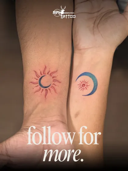A colorful representation of a couple's bond. Using red and blue ink, this matching sun and moon tattoo is a simple yet vibrant symbol of how two people complete one another.