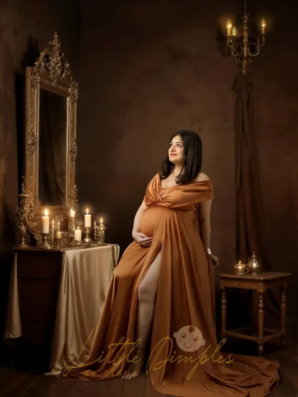Her heart is full, and her glow is real. This fine art portrait in a bronze gown, set in a vintage-inspired corner of my studio, is pure elegance.