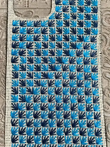 This phone insert showcases a checkerboard-like pattern using a fan stitch, creating a lovely texture.