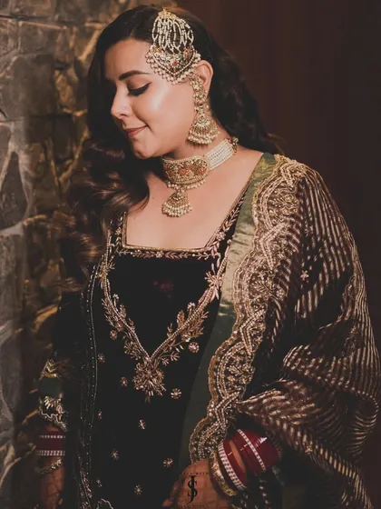 A beautiful side profile of the bride, showcasing her stunning passajewelry and classic Hollywood waves.