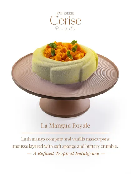This is La Mangue Royale, a refined tropical indulgence. It features a lush mango compote and vanilla mascarpone mousse, layered with soft sponge and a buttery crumble for texture.