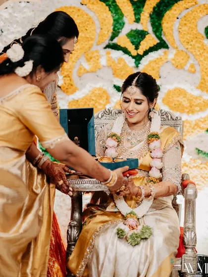 A candid moment from my baby shower, as family members perform traditional rituals.