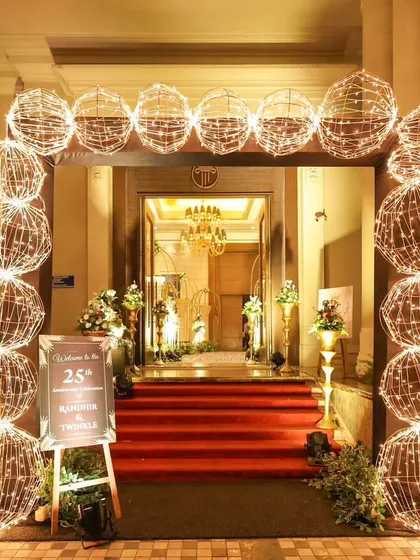 A full view of the elegant light-up arch I created for an anniversary celebration. Paired with a red carpet and a personalized welcome sign, this entrance decor set a festive and celebratory tone right at the door.