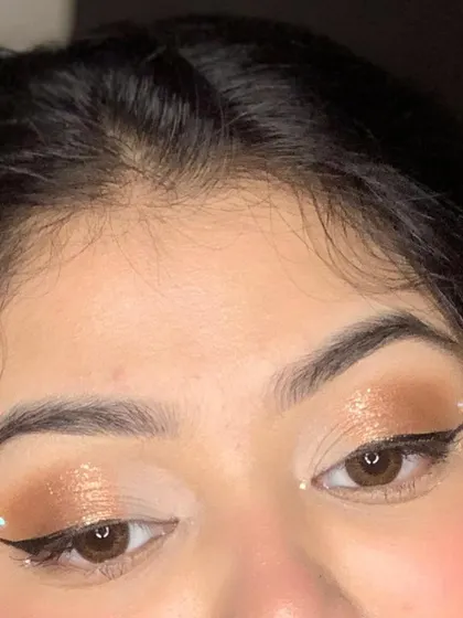 A detailed shot of the eye, showing the subtle glitter and winged liner with dot accents.