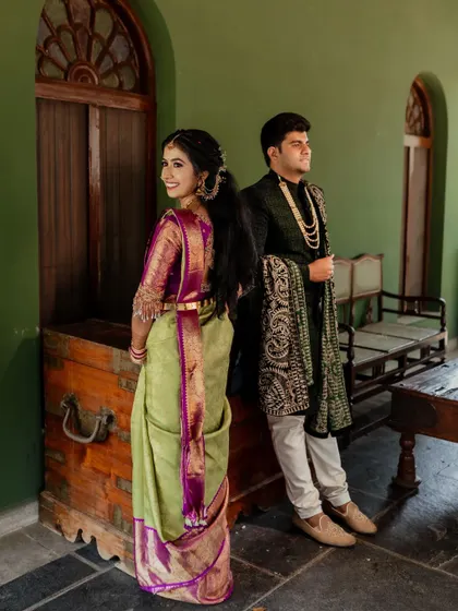 Framed by the rustic charm of The Tamarind Tree, this couple shares a look of love. We specialize in using unique angles and architectural elements to create memorable wedding portraits.