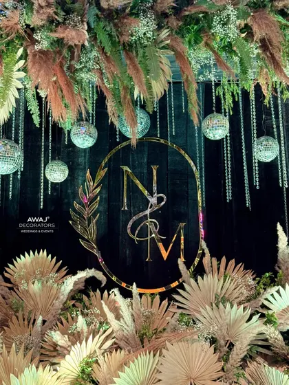 A detailed shot of the monogram and hanging disco balls, a perfect blend of rustic and glamorous styles.