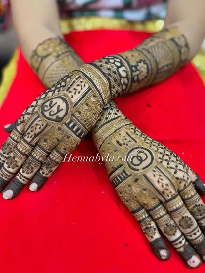 A close-up of the engagement design, highlighting the clean lines of the initials and the intricate patterns surrounding them.
