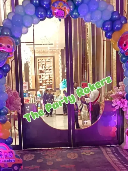A grand entrance arch for a Cocomelon party, decorated with blue and yellow balloons and character cutouts to welcome the little guests.