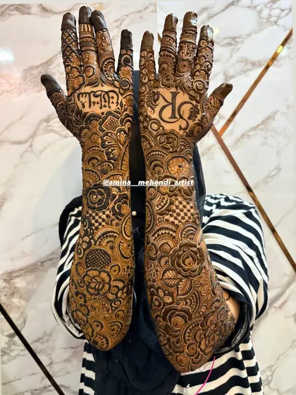 A full-arm design featuring the initials 'SR' and the name 'Sultan' in Urdu, showcasing a mix of personalization and traditional patterns.