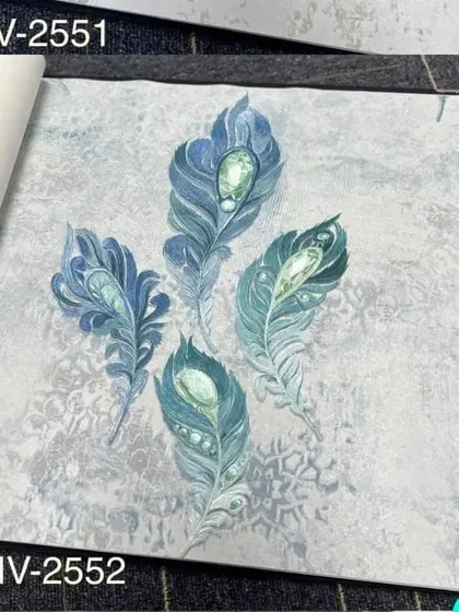 A wallpaper sample with a design of blue and green jeweled peacock feathers on a light grey background.