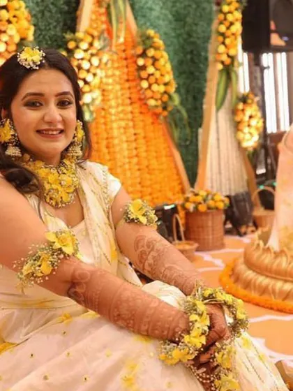 A candid moment from a Haldi ceremony I designed. The backdrop of marigold and tuberose strings provides a classic, fragrant setting that perfectly complements the joyous occasion.