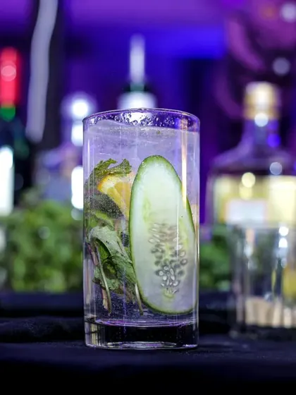 A refreshing cucumber-based cocktail, perfect for a hot day. The clear glass showcases the fresh ingredients, highlighting my commitment to using quality produce.