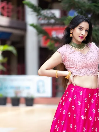 Another shot of Harshika Poonacha, capturing her mid-pose. The movement in her hair and outfit adds a dynamic quality to the image.