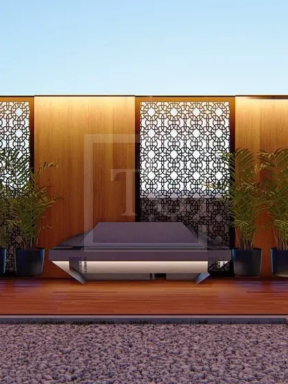 A seating area from the Gurgaon project, featuring a low bench set against a wooden wall with decorative screen panels.
