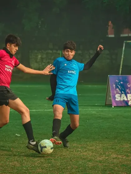A slide tackle comes in during a fast-paced game.