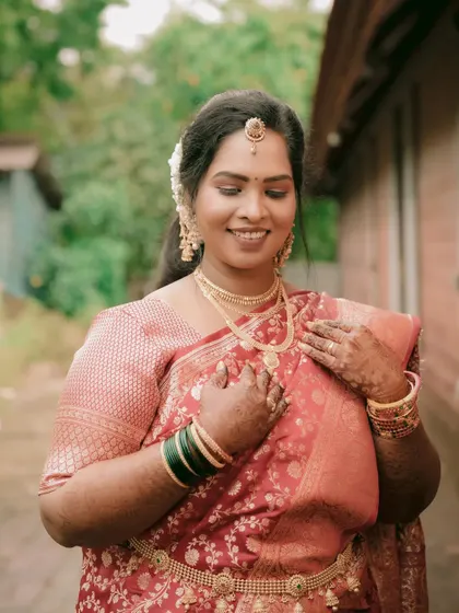 A candid shot of the bride with a gentle, happy smile. This image captures her natural beauty and the joy of her wedding day.